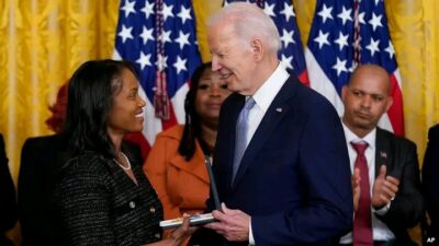 Biden presenting medal to a recipient 