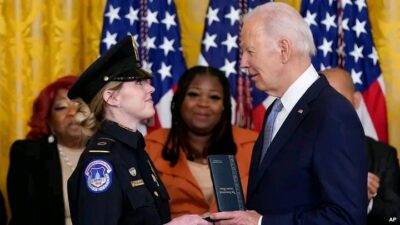 Biden presenting medal to a recipient 