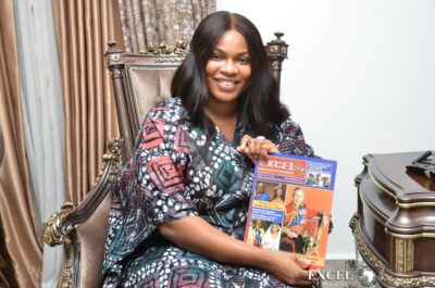 Chief Mrs Iwuanyanwu Holding the Latest Excel Magazine 