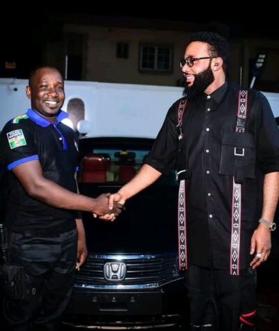 E-Money with his attached police officer 