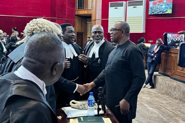 Peter Obi exchanging pleasantries with lawyers during presidential tribunal