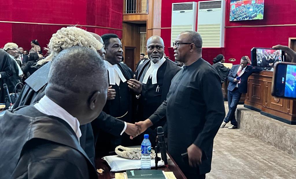 Peter Obi exchanging pleasantries with lawyers during presidential tribunal